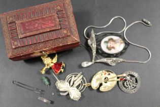 A SMALL ANTIQUE RED LEATHER CASKET BOX AND CONTENTS, INCLUDING A SILVER WOUND BADGE, PORTRAIT