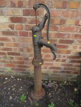 AN ORNAMENTAL CAST OUTSIDE WATER PUMP