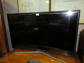 A SAMSUNG 40" CURVED SMART TV WITH REMOTES - HOUSE CLEARANCE