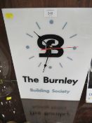 A VINTAGE ADVERTISING CLOCK FOR THE BURNLEY BUILDING SOCIETY TOGETHER WITH ORIGINAL WORKINGS