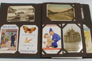 A VINTAGE POSTCARD ALBUM WITH MANY COMICAL EXAMPLES