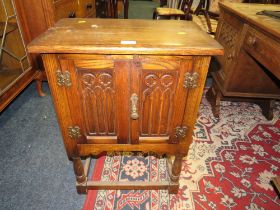 A SMALL OAK GOTHIC TWO DOOR BEDSIDE CUPBOARD