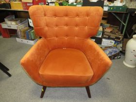 A MODERN BURNT ORANGE UPHOLSTERED ARMCHAIR