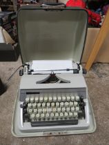 A VINTAGE ADLER GABRIELLE TYPEWRITER IN CASE