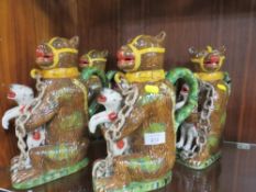 FIVE REPRODUCTION NOVELTY JUGS IN THE FORM OF A CAGE BEAR HOLDING A FELINE