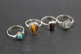 A COLLECTION OF 4 VINTAGE 925 SILVER GEMSTONE DRESS RINGS TO INCLUDE TIGERS EYE, OPAL, GARNET ETC