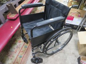 A FOLD AWAY WHEELCHAIR WITH SOLID TYRES AND HANDRAIL