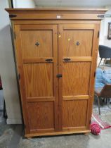 A PITCH PINE TWO DOOR BOOKCASE