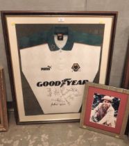 A FRAMED WOLVERHAMPTON WANDERERS SIGNED FOOTBALL CLUB SHIRT WITH A SIGNED SYLVESTER McCOY PHOTOGRAPH