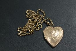 AN ANTIQUE LOCKET AND CHAIN - LOCKET MARKED 9CT BACK AND FRONT