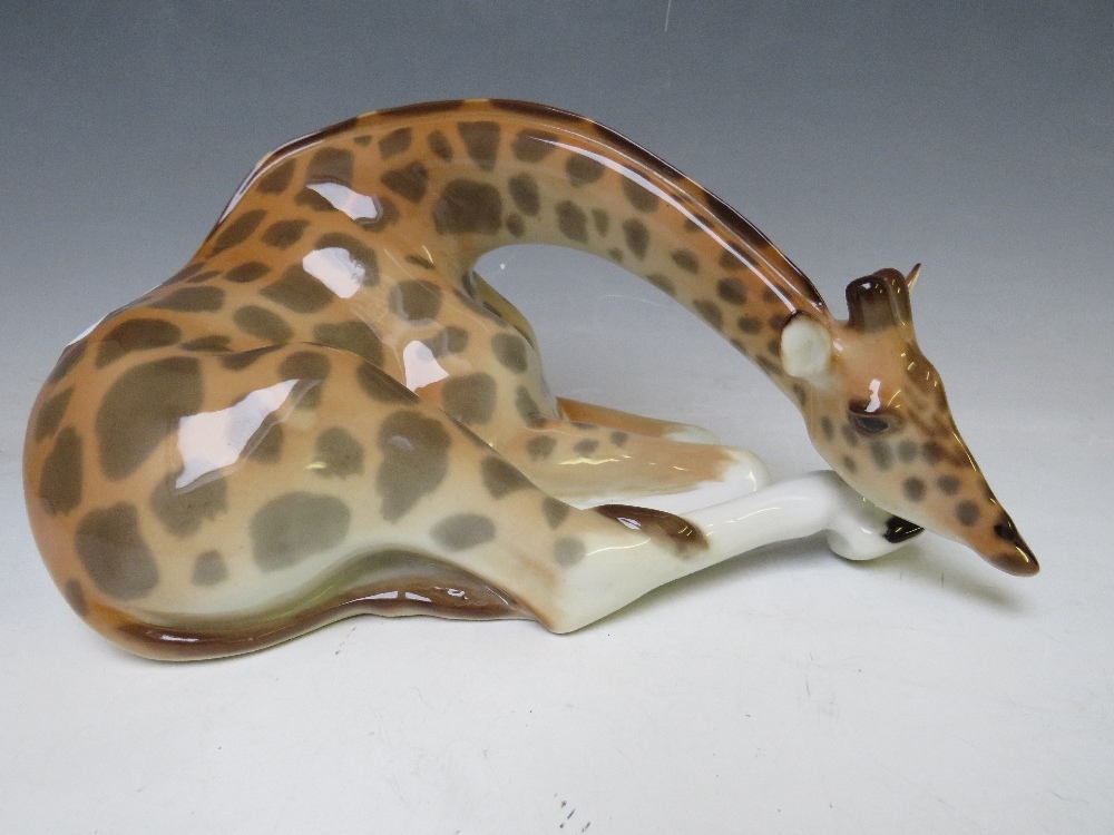 A LOMONOSOV USSR CERAMIC FIGURE OF A RECUMBERENT GIRAFFE