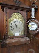 A VINTAGE MAHOGANY MANTLE CLOCK TOGETHER WITH AN ORNATE WALL MOUNTED BAROMETER