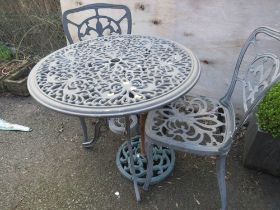 A CAST ALUMINIUM GARDEN TABLE SET TO INCLUDE TABLE, TWO CHAIRS AND PARASOL BASE