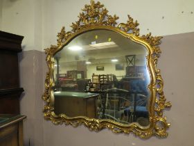 A LARGE GILT WALL MIRROR 115 X 122 CM