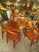 A MODERN PINE EXTENDING PEDESTAL TABLE AND FIVE CHAIRS