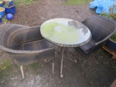 A RATTAN GARDEN PATIO TABLE AND TWO CHAIRS