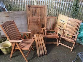 A RECTANGLE HARDWOOD GARDEN TABLE WITH FOUR FOLDING CHAIRS