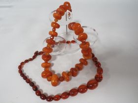 AN UNUSUAL VINTAGE AMBER BEAD NECKLACE, the chunky disc shaped amber bead interspersed with small