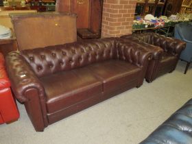 A BROWN CHESTERFIELD SETTEE AND ARMCHAIR