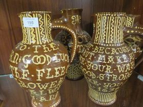 FOUR ANTIQUE STYLE SLIP WARE JUGS