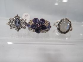 THREE DECORATIVE SILVER DRESS RINGS TO INCLUDE A MOONSTONE STYLE EXAMPLE
