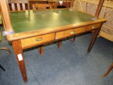 A VINTAGE OAK LEATHER TOPPED THREE DRAWER LIBRARY DESK W-152 CM