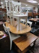 A PINE TWIN PEDESTAL EXTENDING TABLE WITH SIX CHAIRS AND COFFEE TABLE
