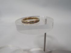 AN 18K CHANNEL SET DIAMOND FULL ETERNITY RING ring size n 1/2 approx weight 3.9g