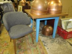 A CHUNKY MODERN BISTRO TABLE WITH AN UPHOLSTERED CHAIR