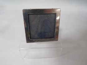 A HALLMARKED SILVER SMALL SQUARE PHOTO FRAME