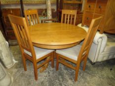 A MODERN OAK EXTENDING PEDESTAL TABLE AND FOUR CHAIRS