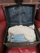 A TIN TRUNK CONTAINING A VINTAGE WEDDING DRESS TOGETHER WITH OTHER VINTAGE CLOTHING