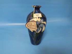 A COBRIDGE TRIAL BALUSTER VASE, decorated with blue floral pattern, impressed factory marks, H 24