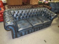 A BLUE CHESTERFIELD THREE SEATER SETTEE