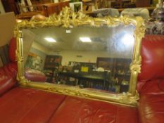 A MODERN CARVED GILT OVERMANTLE MIRROR 88 X 140 CM