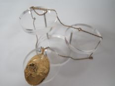 A LOCKET AND CHAIN - LOCKET MARKED ROLLED GOLD