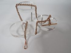 A GRADUATING 9CT ROSE GOLD ALBERT CHAIN WITH T-BAR, stamped on every link although many rubbed,