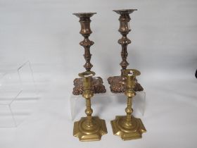 A PAIR OF 18TH CENTURY GEORGE II BRASS CANDLESTICKS AND A PAIR OF GEORGE II STYLE PLATED STICKS