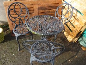 A CAST ALUMINIUM GARDEN PATIO TABLE SET WITH THREE CHAIRS