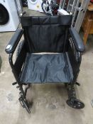 A FOLD AWAY WHEELCHAIR WITH SOLID TYRES AND HANDRAIL