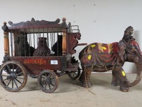 A LARGE VINTAGE WOODEN CIRCUS TRAILER WITH AN ELEPHANT