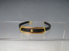 AN UNUSUAL HALLMARKED 14K GOLD AND TEXTILE BRACELET, in the design of a 'buckle' on a rubber