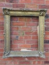 A GILT RECTANGULAR PICTURE FRAME, with raised moulded foliate detail, rebate 65 x 52 cm