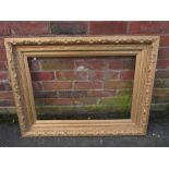 A GILT RECTANGULAR PICTURE FRAME, foliate moulded detail throughout, rebate 75 x 50 cm