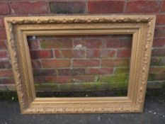 A GILT RECTANGULAR PICTURE FRAME, foliate moulded detail throughout, rebate 75 x 50 cm