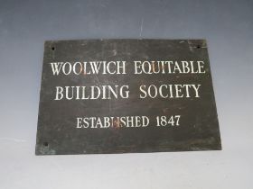 A VINTAGE METAL PLAQUE FOR THE WOOLWICH EQUITABLE BUILDING SOCIETY EST. 1847, 20 x 30 cm