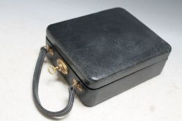 A SMALL TRAVELLING VANITY CASE WITH HALLMARKED SILVER GILT ACCESSORIES, complete with a base metal