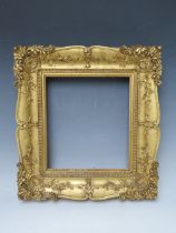 A 19TH CENTURY DECORATIVE GOLD SWEPT FRAME, frame W 6.5 cm, rebate 23 x 20 cm