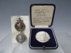 A CASED SILVER SWIMMING MEDAL - CHESTER 1934, together with two hallmarked silver fobs (3)