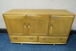 AN ERCOL LIGHT ELM SIDEBOARD, with two drawers, on castors, W 130 cm